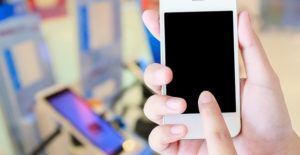 a woman shows off a cell phone