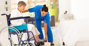 a nurse helps a senior in a wheelchair