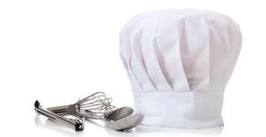 a chef hat and culinary utensils