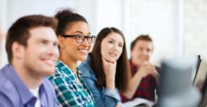 4 diverse students listen to information about the marketing major