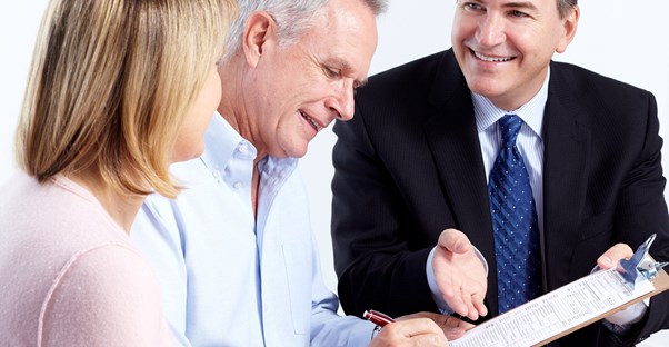 a couple discuss their retirement planning options with an advisor
