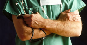 a doctor crosses his arms across his chest