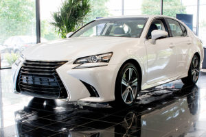 a white lexus gs sitting in a showroom