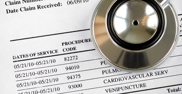 a stethoscope on top of medical billing information