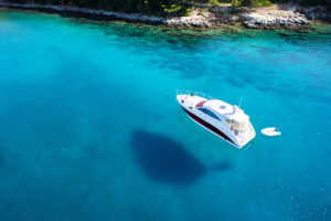 a boat covered by boat insurance on clear blue water