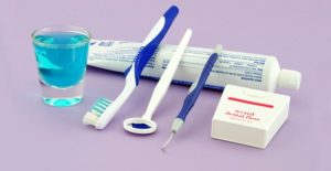 a collection of oral hygiene tools including toothbrush, floss, and mouthwash