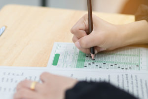 a student fills out an lsat exam sheet