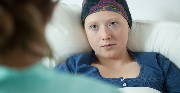a female patient with a leukemia sits in bed