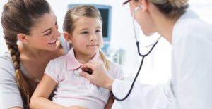 a pediatrician examines a child